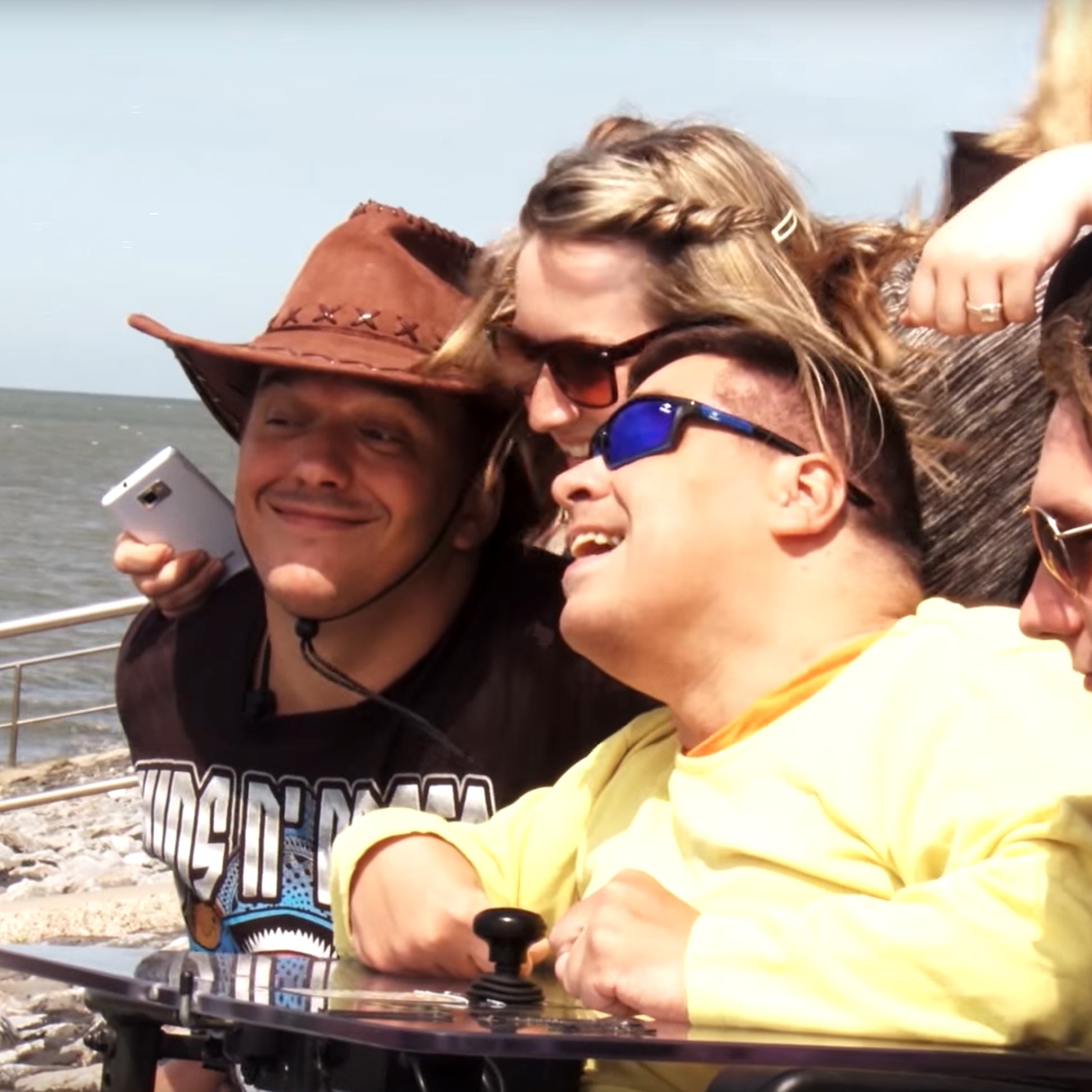 Drei Menschen vom KBV sind am Strand und machen ein Foto von sich.